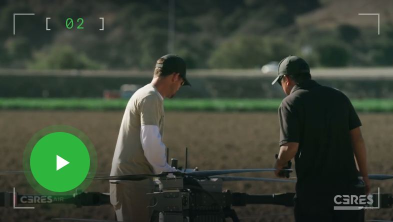 Two growers setting up a Ceres drone in a field, play video